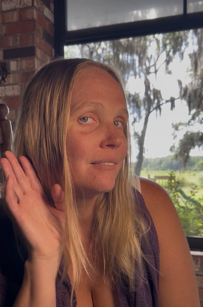 Mandie Jones on a porch, Spanish moss and open pasture behind her