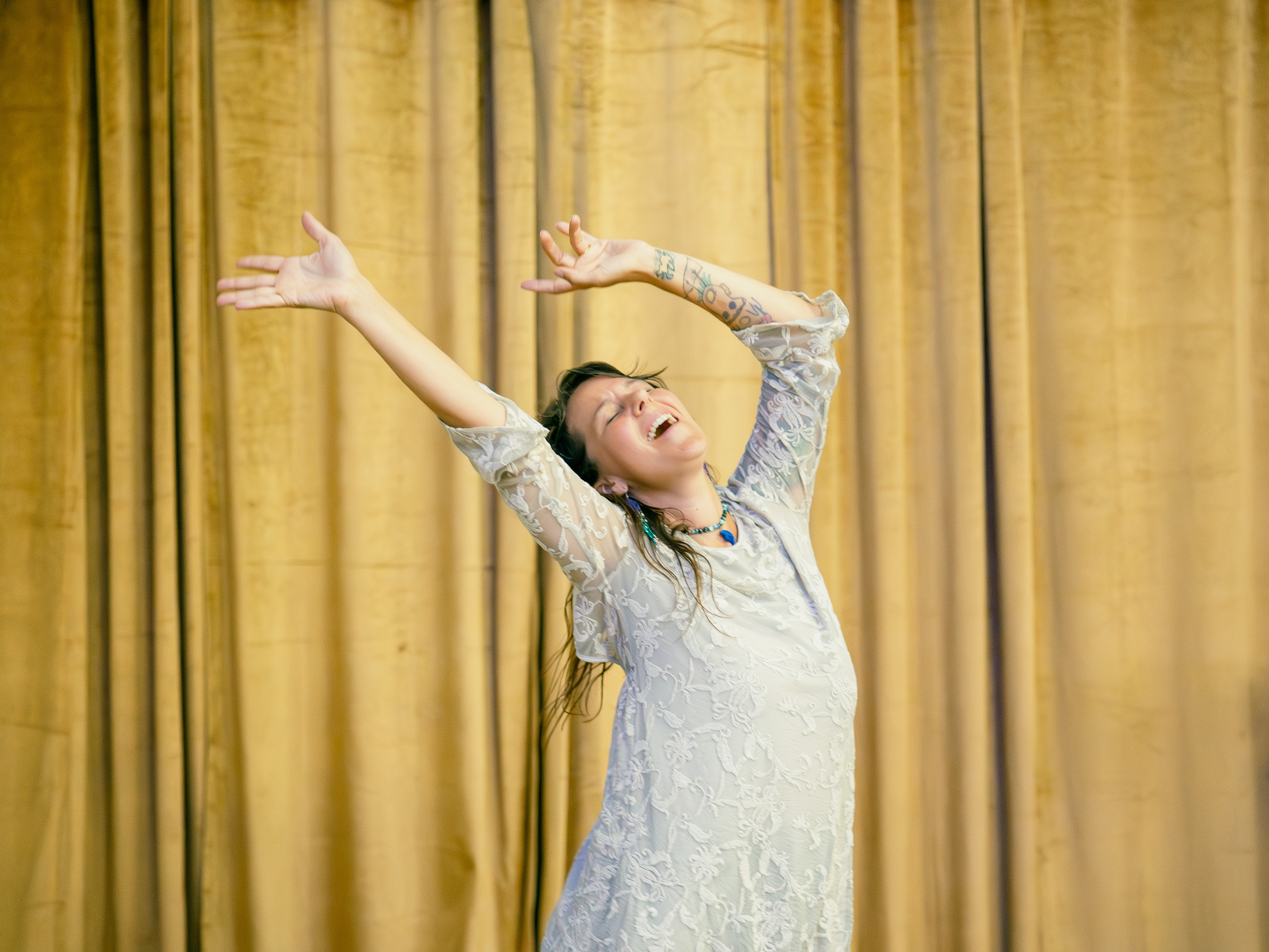 Nicole facilitating an ecstatic dance session with participants on a purple mat