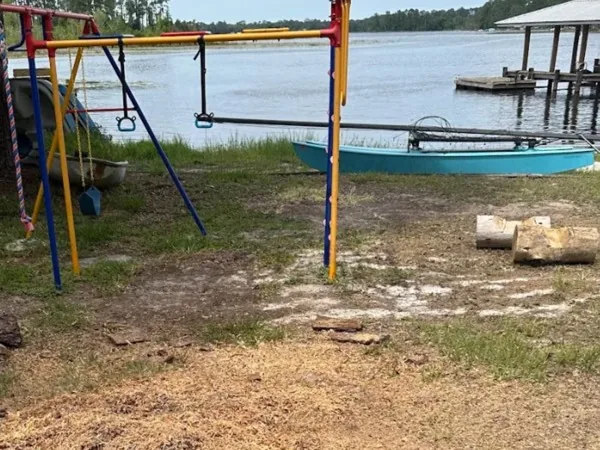 The same spot after grinding, the stump gone and the ground raked level